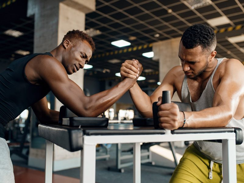 two-men-fighting-arm-wrestling-training-in-gym-CQ468DL-min.jpg